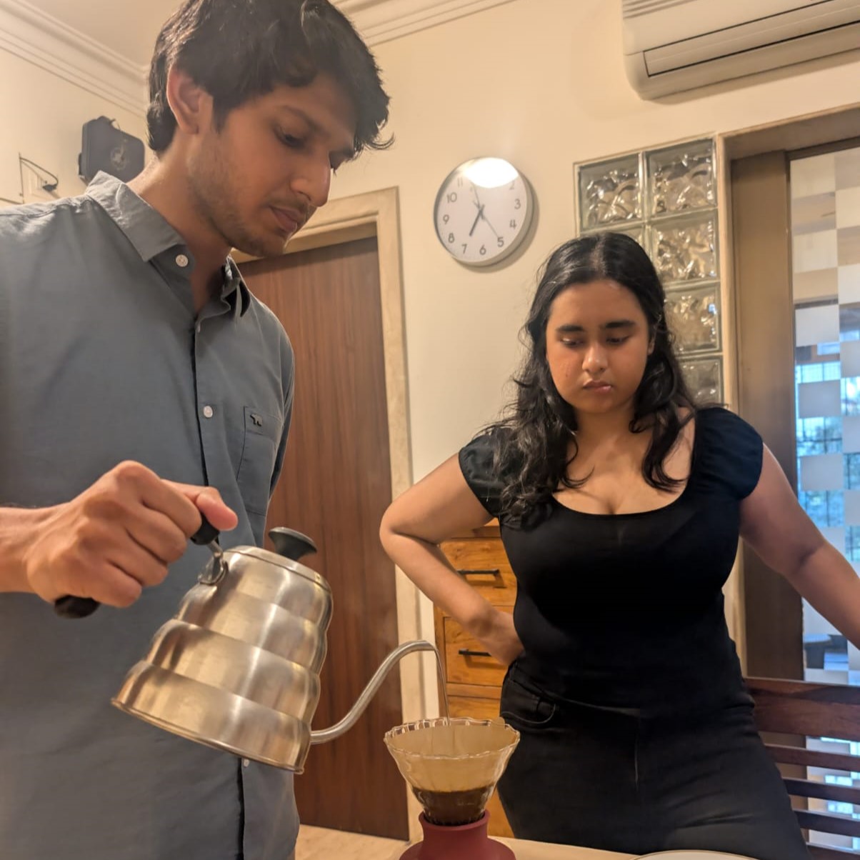 Pouring filter coffee at a past Coffee Club table